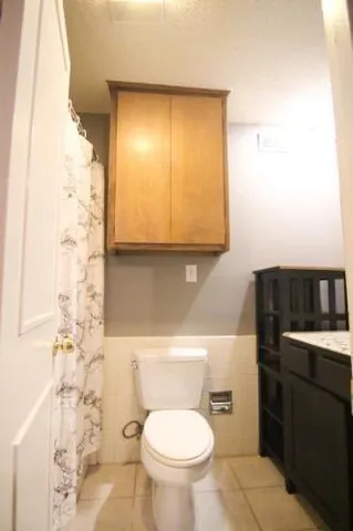 a bathroom with a toilet a sink and a mirror