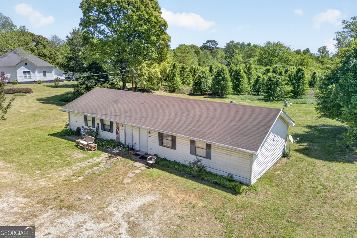481 Main Street Clermont, GA 30527 - Photo 11 of 43 an aerial view of residential houses with yard and trees