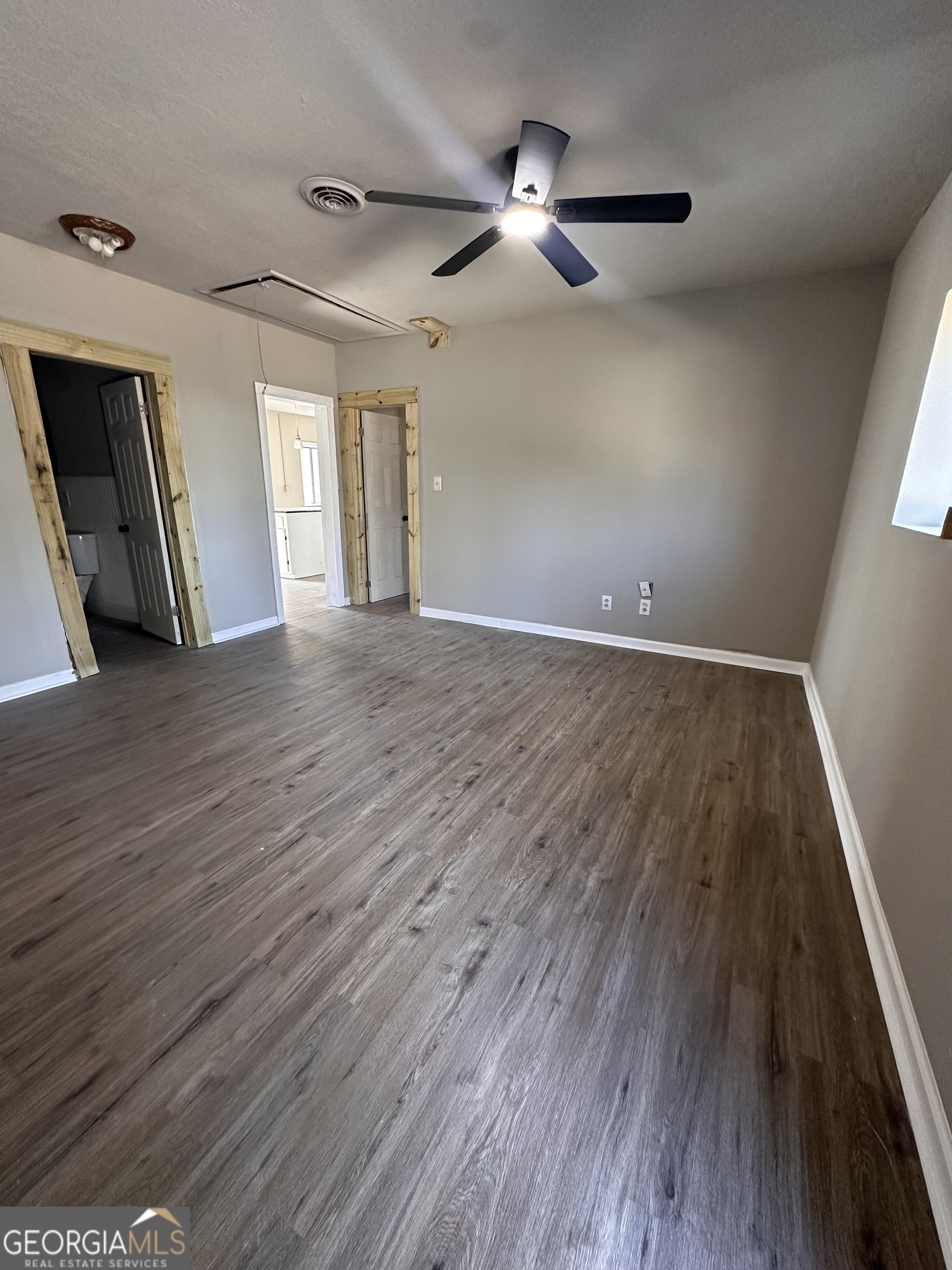 481 Main Street Clermont, GA 30527 - Photo 12 of 43 wooden floor in an empty room with a window
