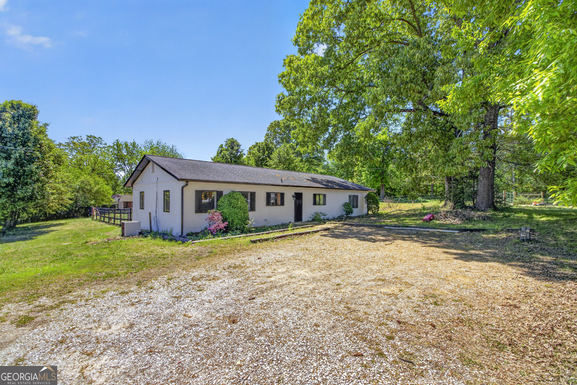 481 Main Street Clermont, GA 30527 - Photo 13 of 43 a front view of a house with a garden