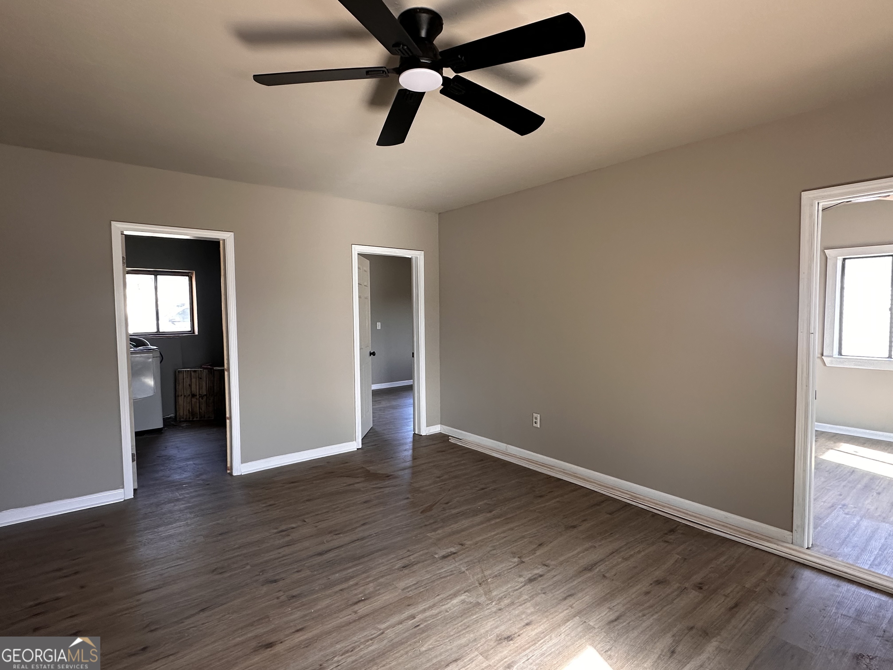 481 Main Street Clermont, GA 30527 - Photo 20 of 43 an empty room with wooden floor cabinet and windows