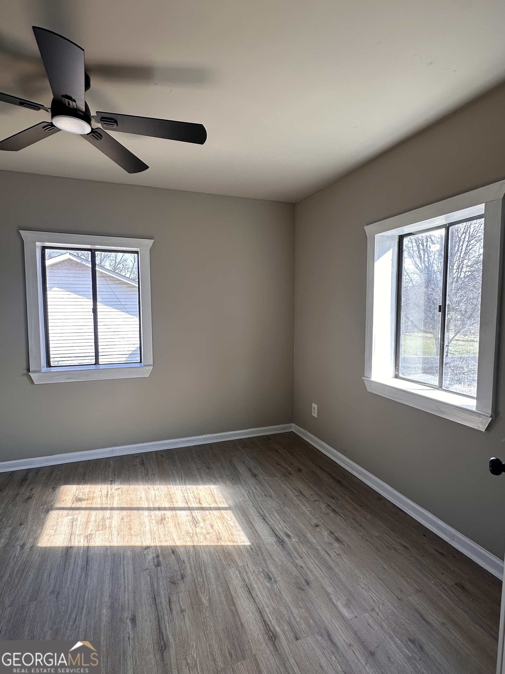 481 Main Street Clermont, GA 30527 - Photo 22 of 43 a view of empty room with wooden floor and fan