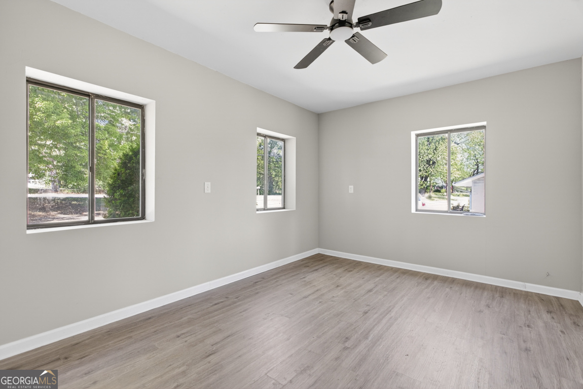 481 Main Street Clermont, GA 30527 - Photo 27 of 43 a view of empty room with wooden floor and fan