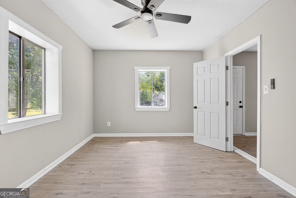 481 Main Street Clermont, GA 30527 - Photo 29 of 43 a view of an empty room with a window and wooden floor