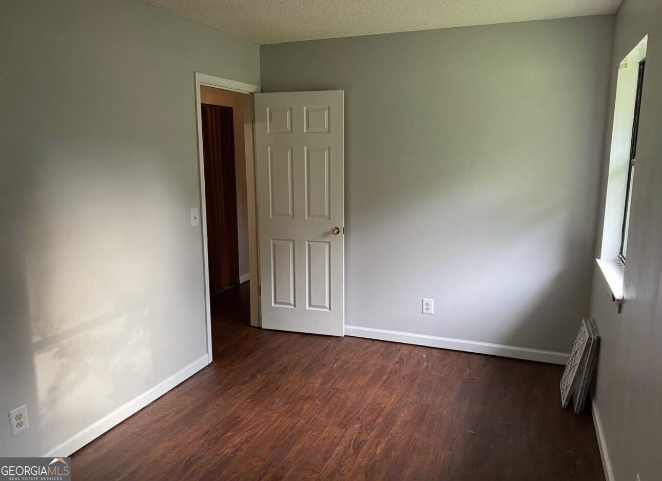 481 Main Street Clermont, GA 30527 - Photo 30 of 43 an empty room with wooden floor and windows