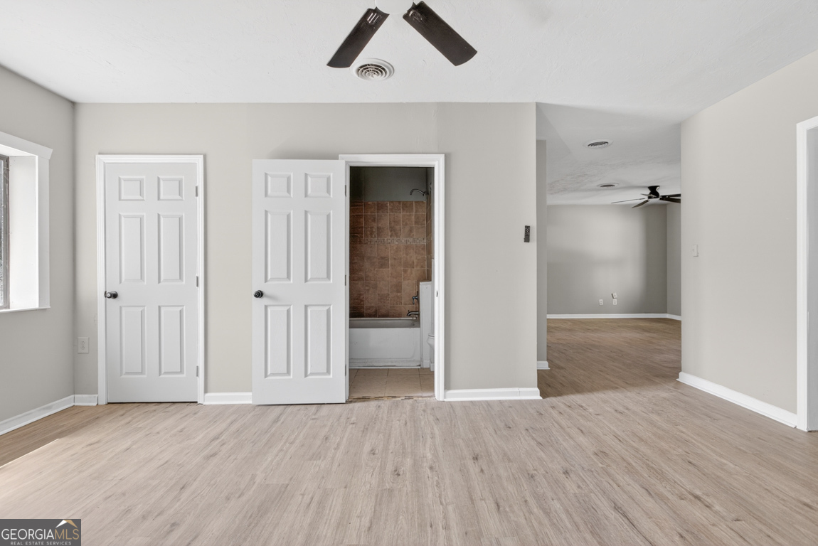 481 Main Street Clermont, GA 30527 - Photo 31 of 43 a view of empty room with wooden floor and ceiling fan