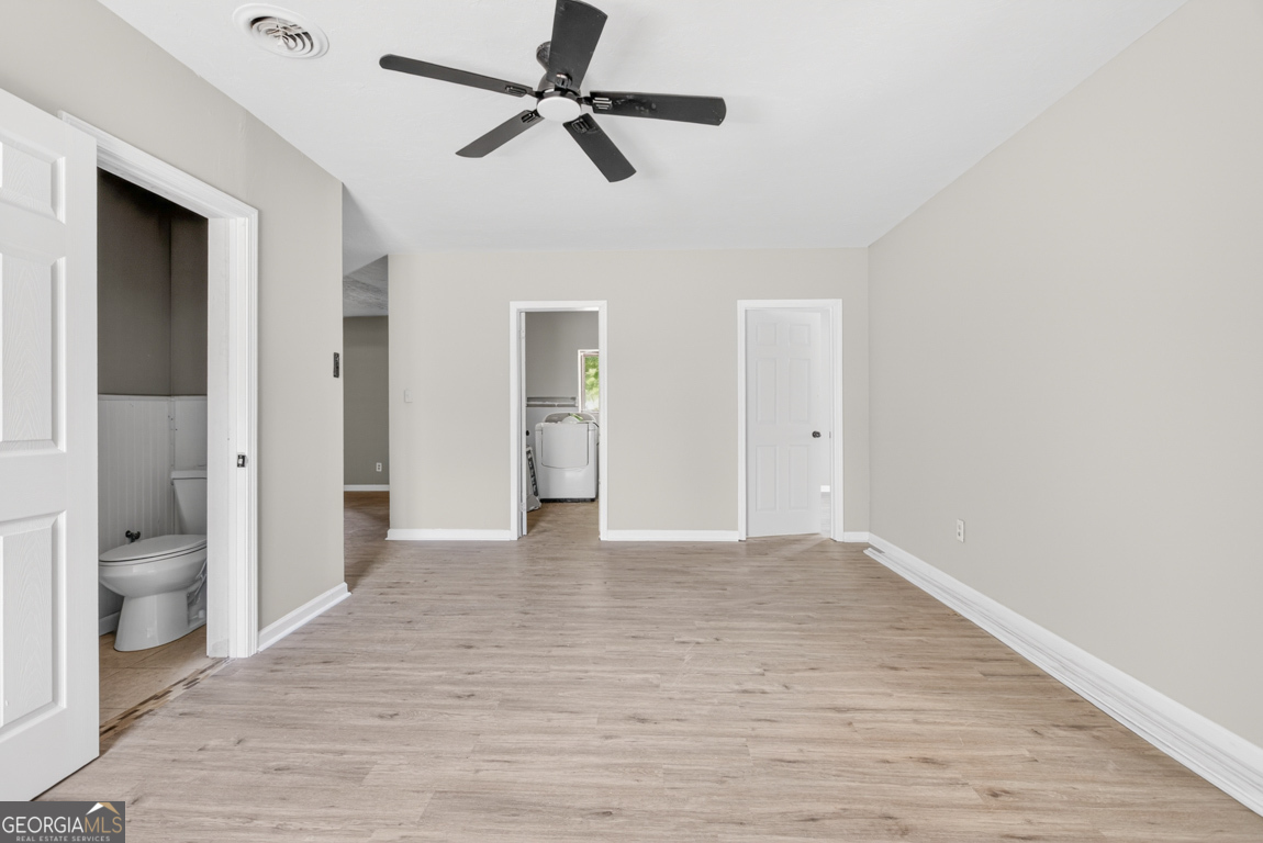 481 Main Street Clermont, GA 30527 - Photo 32 of 43 a view of a big room with wooden floor and windows