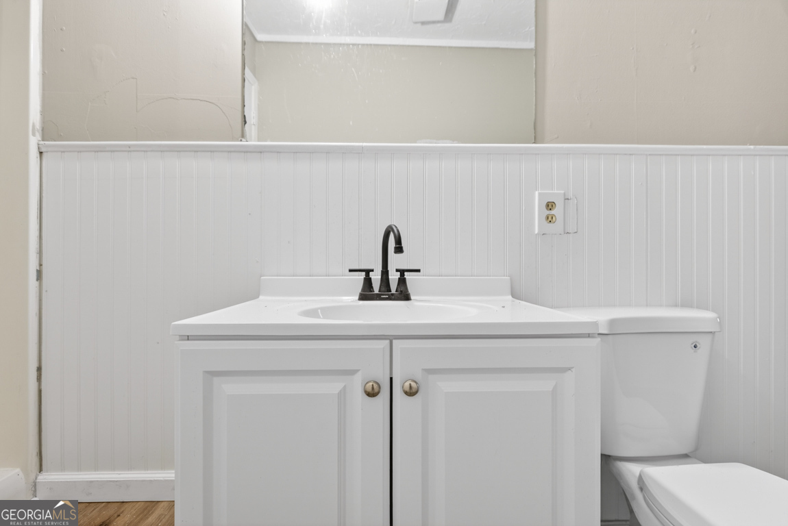 481 Main Street Clermont, GA 30527 - Photo 34 of 43 a bathroom with a toilet sink and mirror