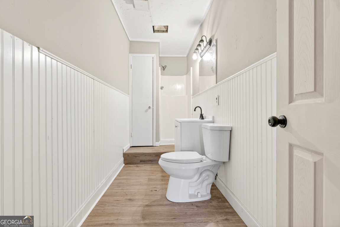 481 Main Street Clermont, GA 30527 - Photo 35 of 43 a bathroom with a toilet and a mirror