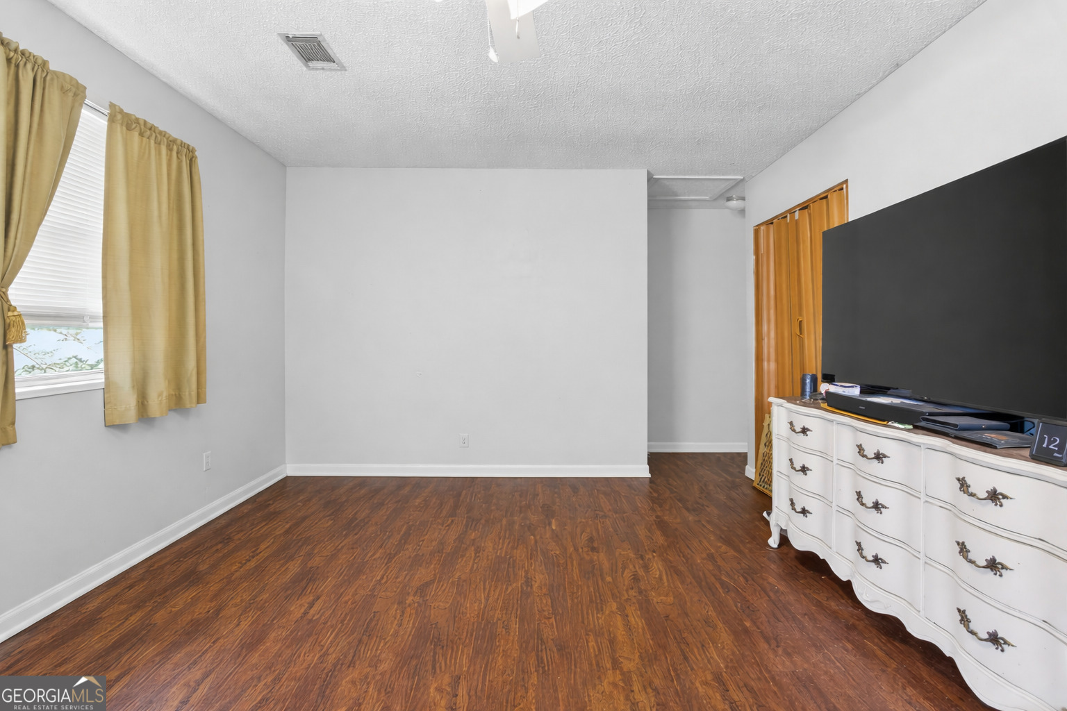 481 Main Street Clermont, GA 30527 - Photo 38 of 43 a view of an empty room with wooden floor and a window