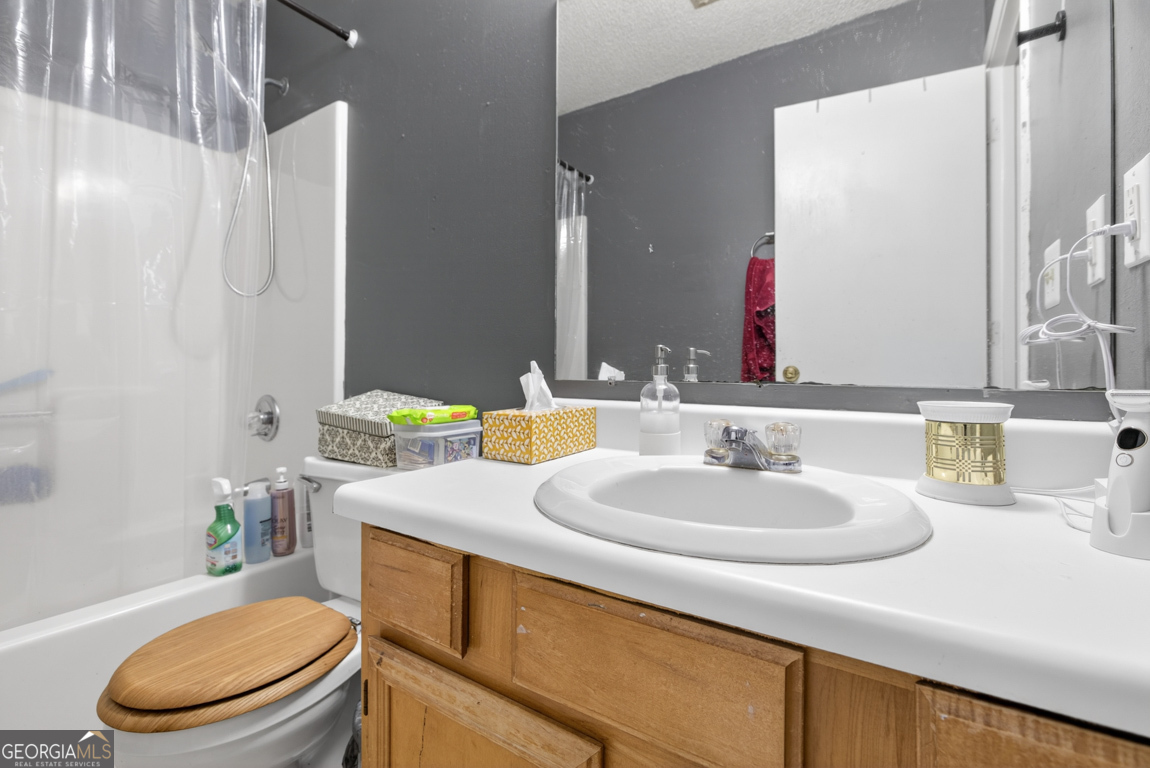 481 Main Street Clermont, GA 30527 - Photo 39 of 43 a bathroom with a sink a toilet and a mirror
