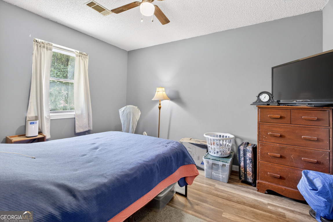 481 Main Street Clermont, GA 30527 - Photo 40 of 43 a bedroom with a bed and flat tv screen