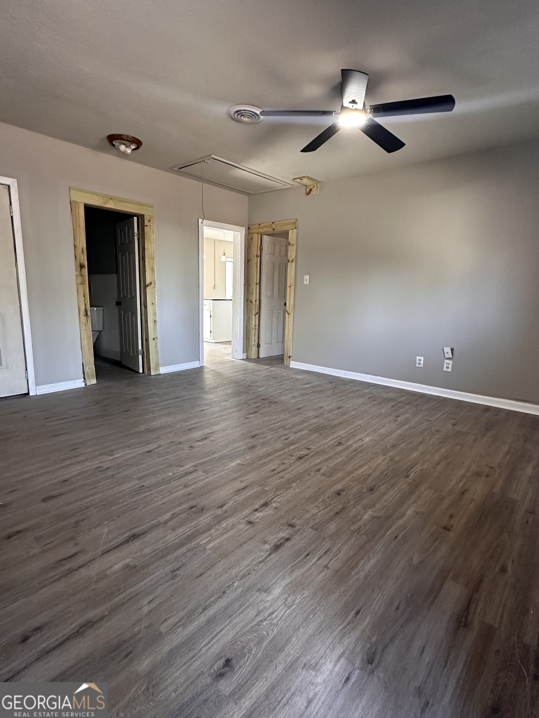 481 Main Street Clermont, GA 30527 - Photo 8 of 43 a view of an empty room with window and wooden floor