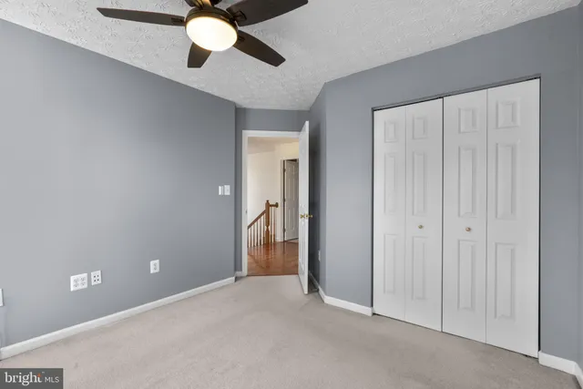 a bathroom with a granite countertop sink mirror toilet and bathtub