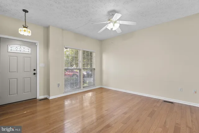wooden floor in an empty room with a window