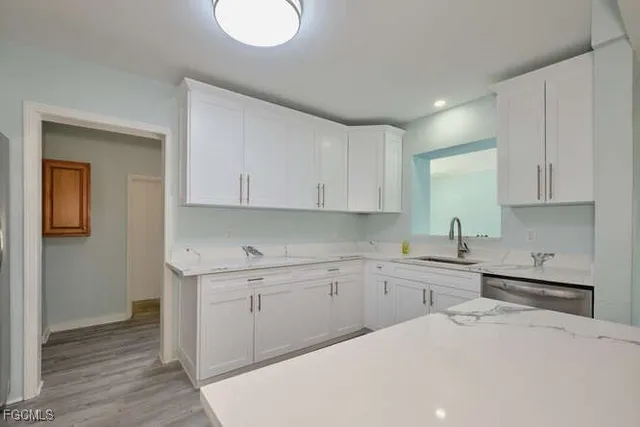 a kitchen with a sink a stove and cabinets