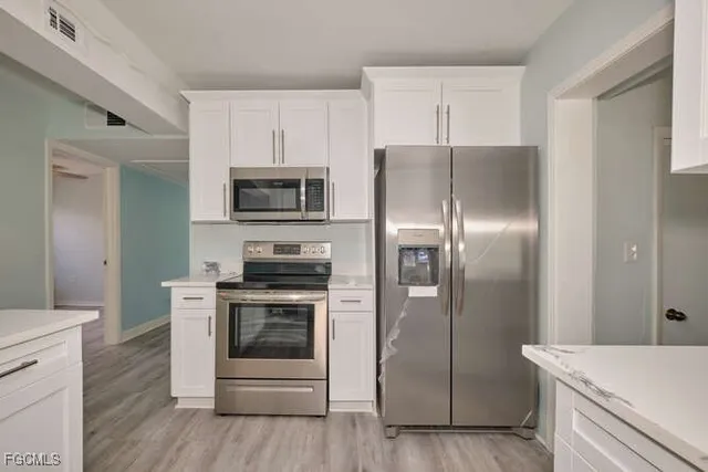 a kitchen with a refrigerator stove and microwave