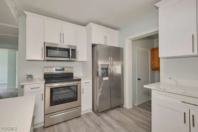 a kitchen with a stove microwave and refrigerator