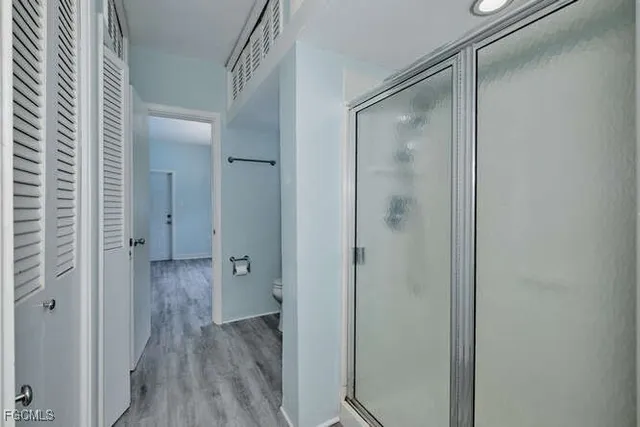 a bathroom with a glass shower door