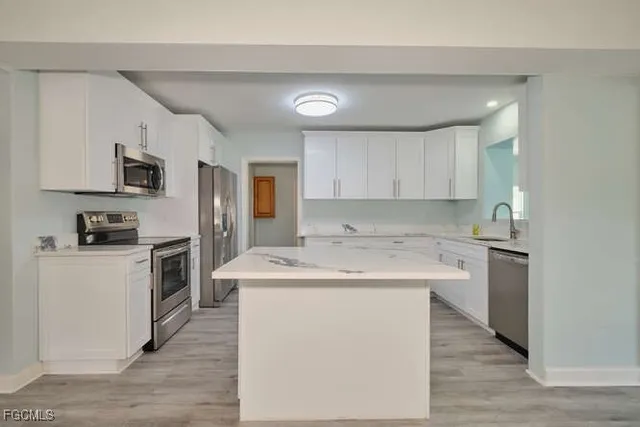 a kitchen with a sink stove and refrigerator