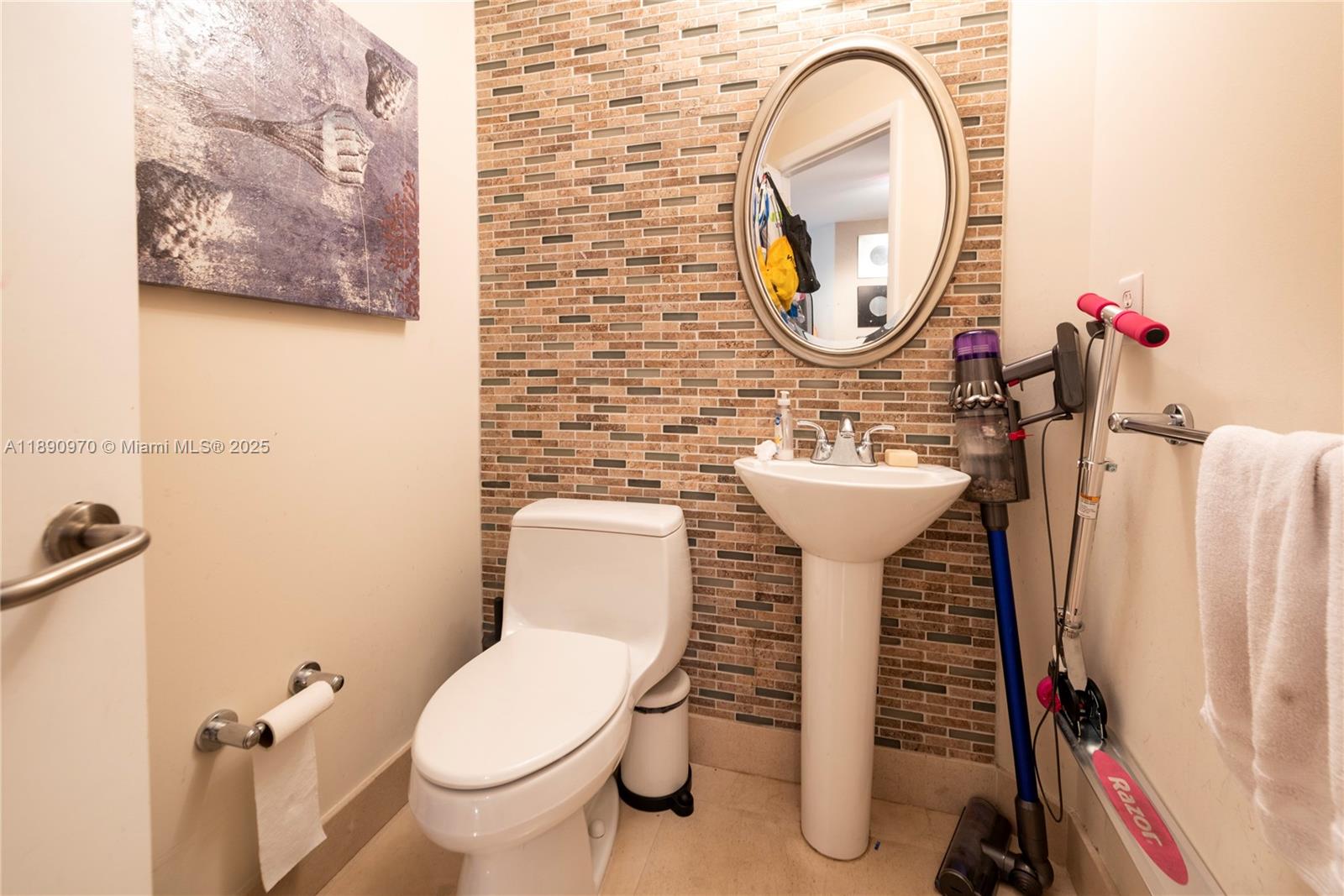3131 Northeast 188th Street, Unit 2808 Aventura, FL 33180 - Photo 15 of 33 a bathroom with a toilet sink and mirror