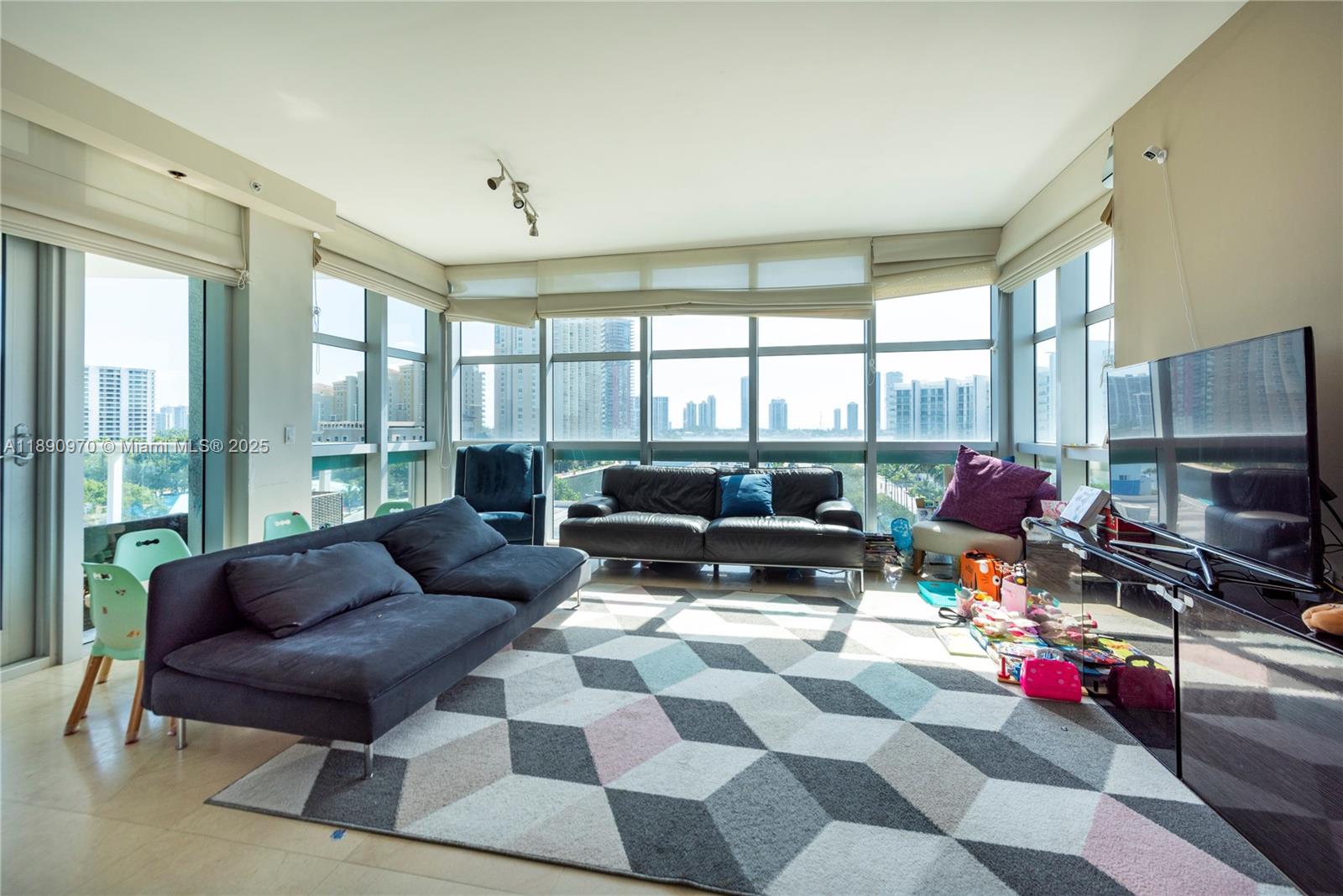 3131 Northeast 188th Street, Unit 2808 Aventura, FL 33180 - Photo 3 of 33 a living room with furniture a rug and a floor to ceiling window