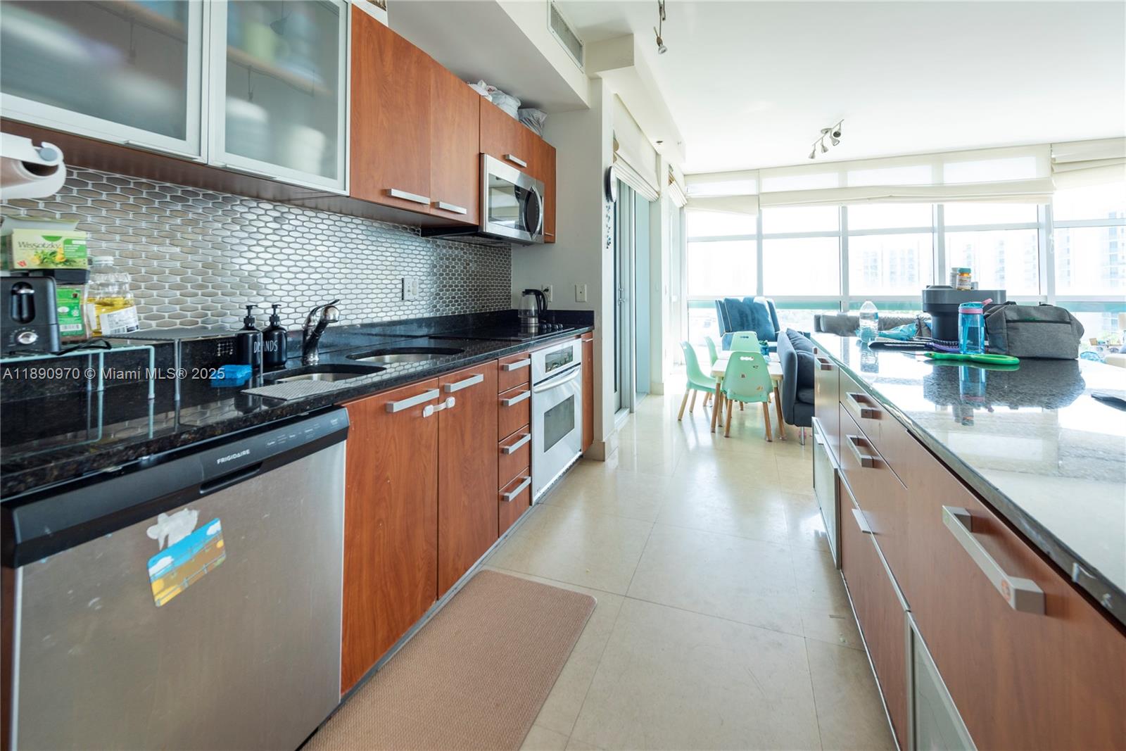 3131 Northeast 188th Street, Unit 2808 Aventura, FL 33180 - Photo 5 of 33 a kitchen with stainless steel appliances granite countertop a sink a stove and a wooden floors