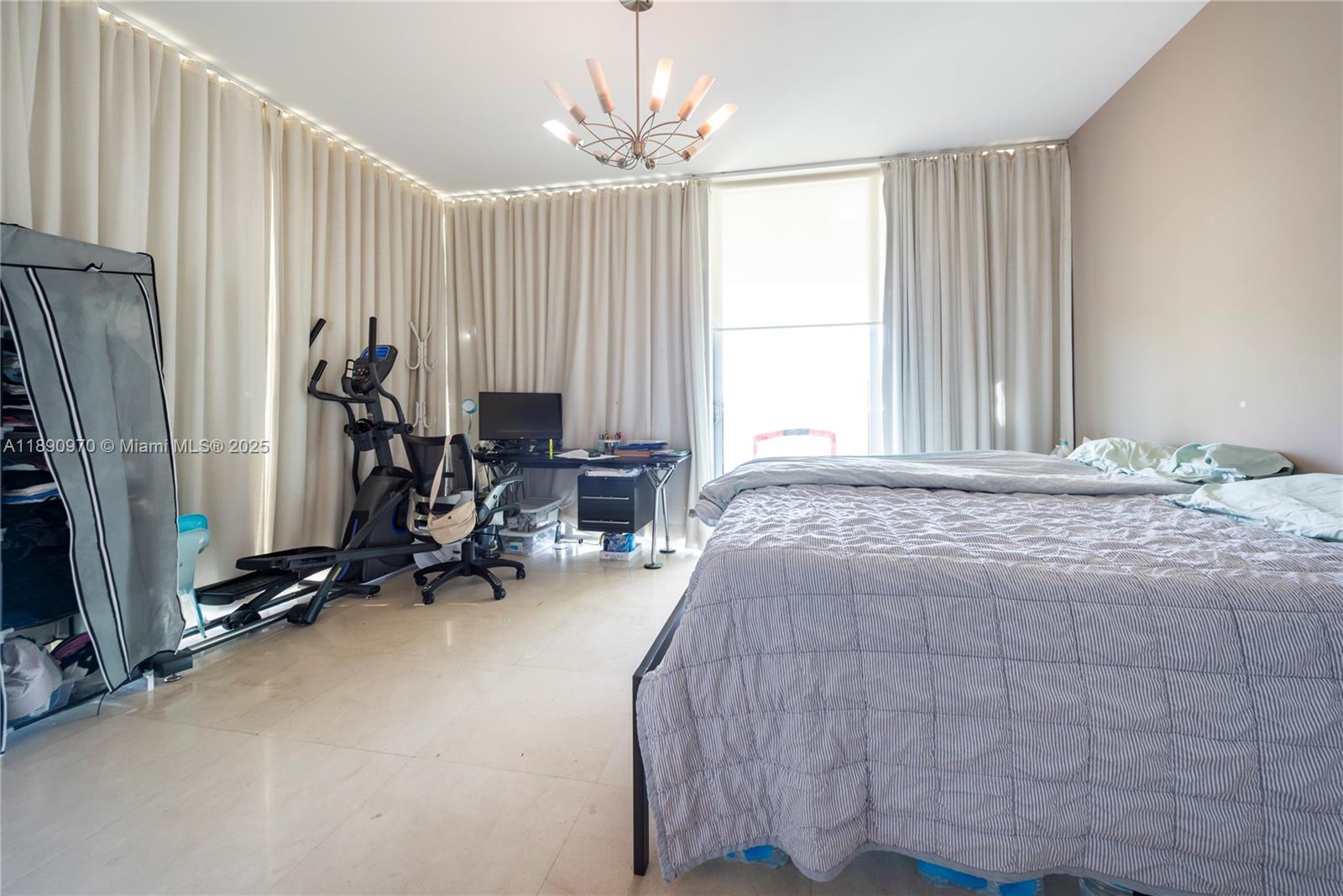 3131 Northeast 188th Street, Unit 2808 Aventura, FL 33180 - Photo 9 of 33 a bedroom with a bed a table and a large mirror