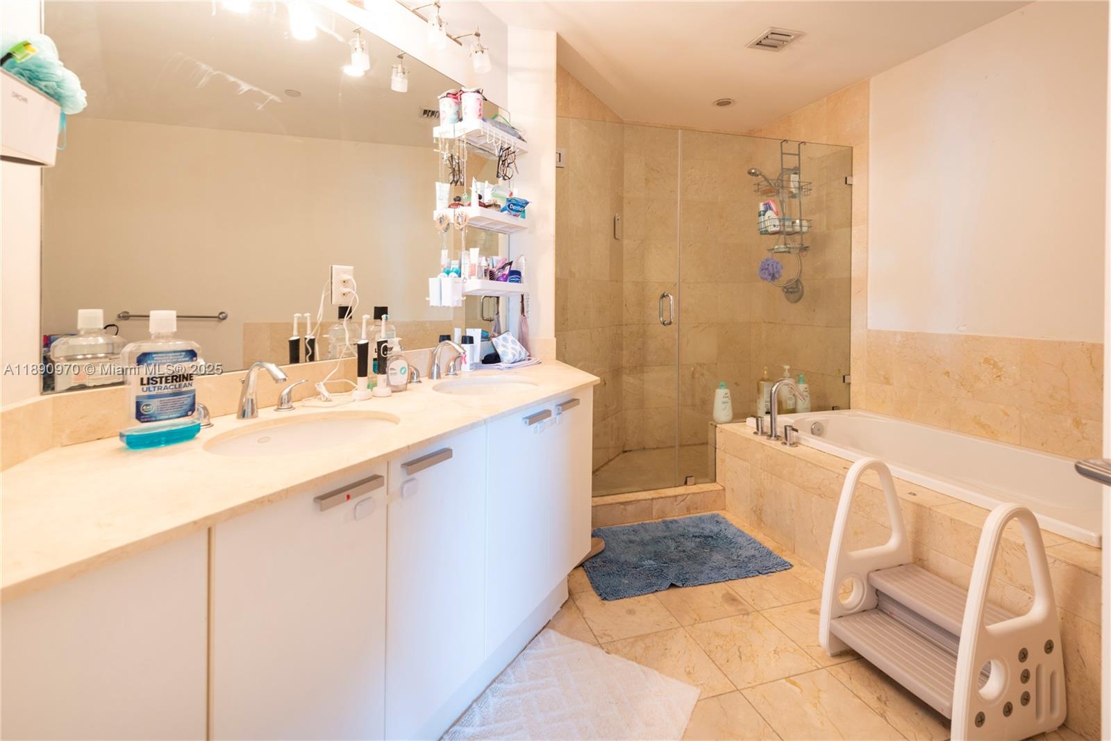 3131 Northeast 188th Street, Unit 2808 Aventura, FL 33180 - Photo 10 of 33 a bathroom with a tub sink and mirror