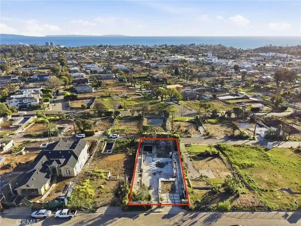 an aerial view of residential houses with city view