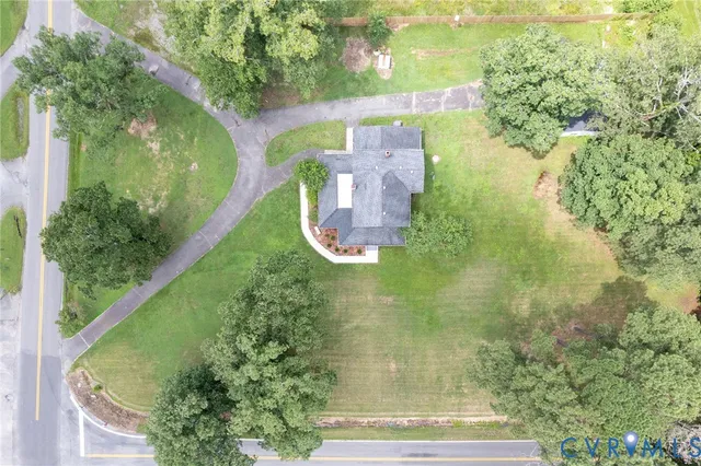 an aerial view of a residential houses with outdoor space