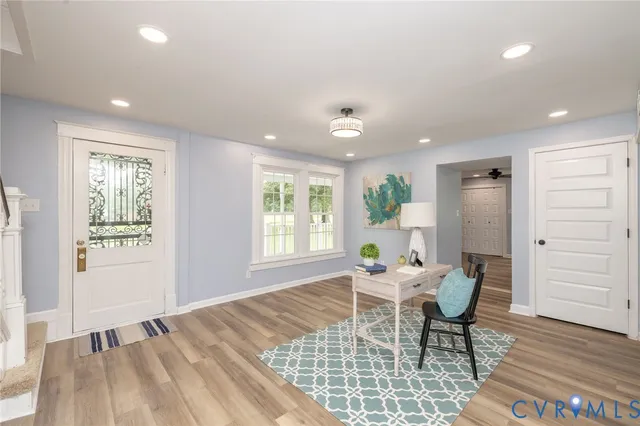 a living room with furniture and wooden floor