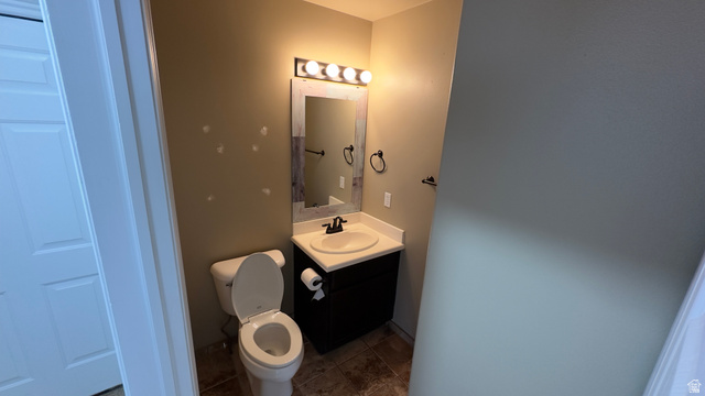 3547 East Golden Eagle Road Eagle Mountain, UT 84005 - Photo 13 of 47 Half bath with vanity and dark tile patterned floors