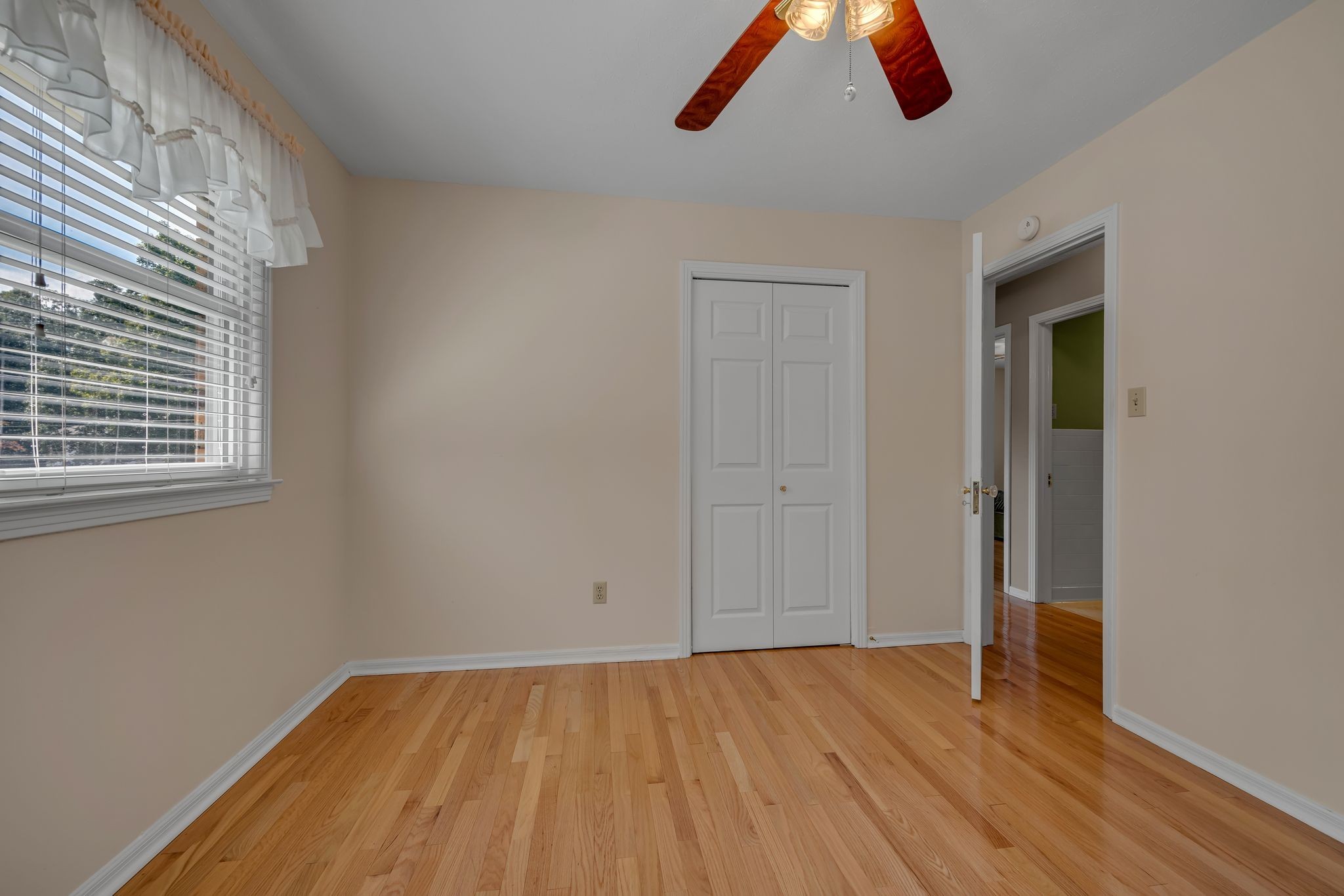 126 Robin Hood Road Dickson, TN 37055 - Photo 14 of 31 an empty room with wooden floor chandelier fan and windows