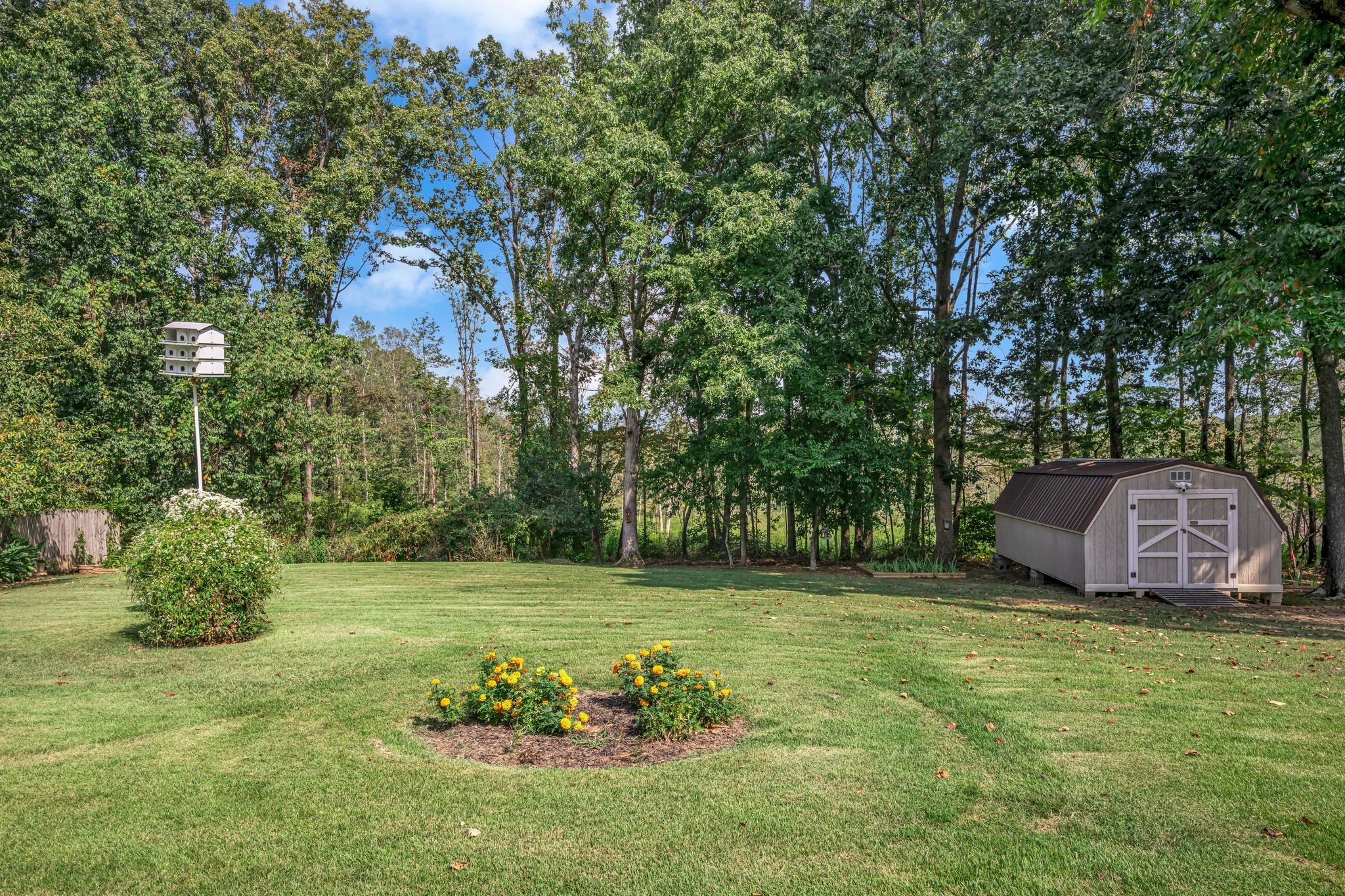 126 Robin Hood Road Dickson, TN 37055 - Photo 17 of 31 a view of a backyard with a garden and entertaining space
