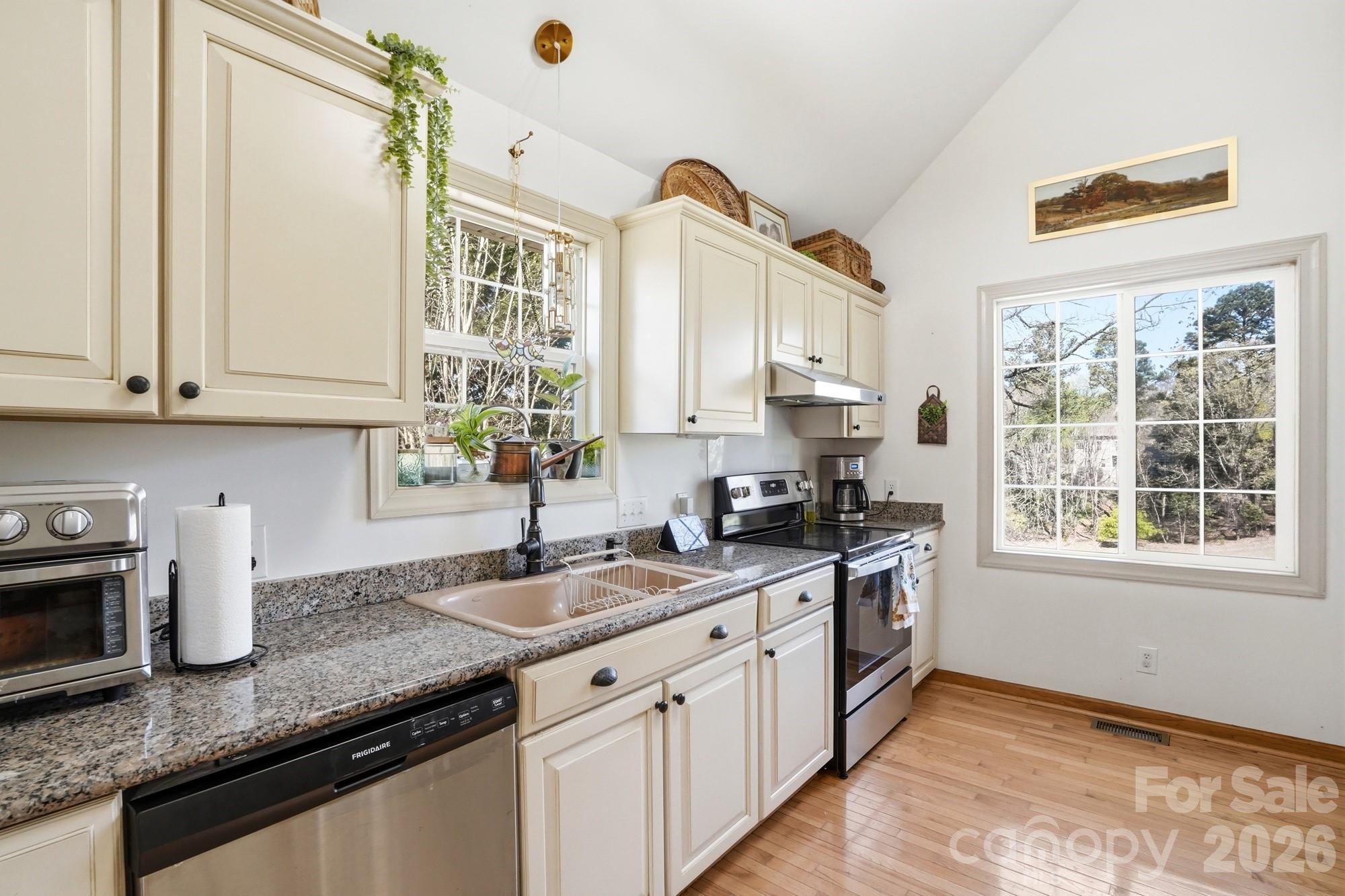 6046 Windjammer Drive Tega Cay, SC 29708 - Photo 17 of 46 a kitchen with granite countertop a sink stove and cabinets