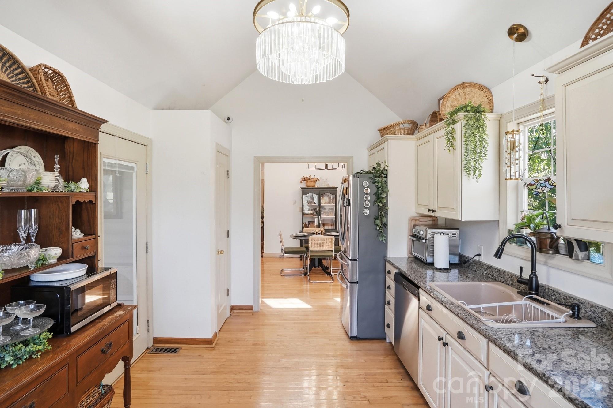 6046 Windjammer Drive Tega Cay, SC 29708 - Photo 20 of 46 a kitchen with granite countertop a stove and a sink