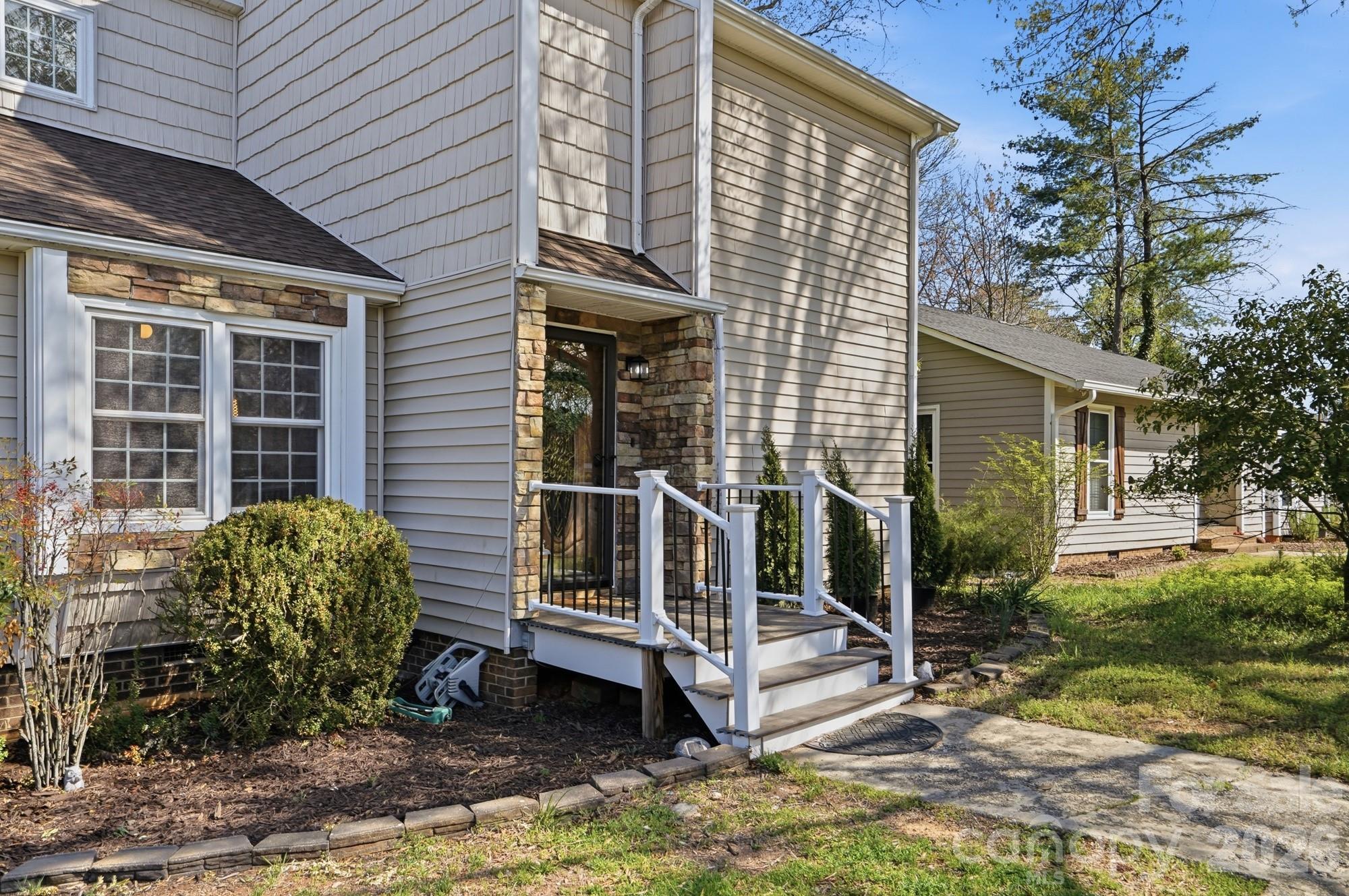 6046 Windjammer Drive Tega Cay, SC 29708 - Photo 2 of 46 a view of a house with a yard and sitting area