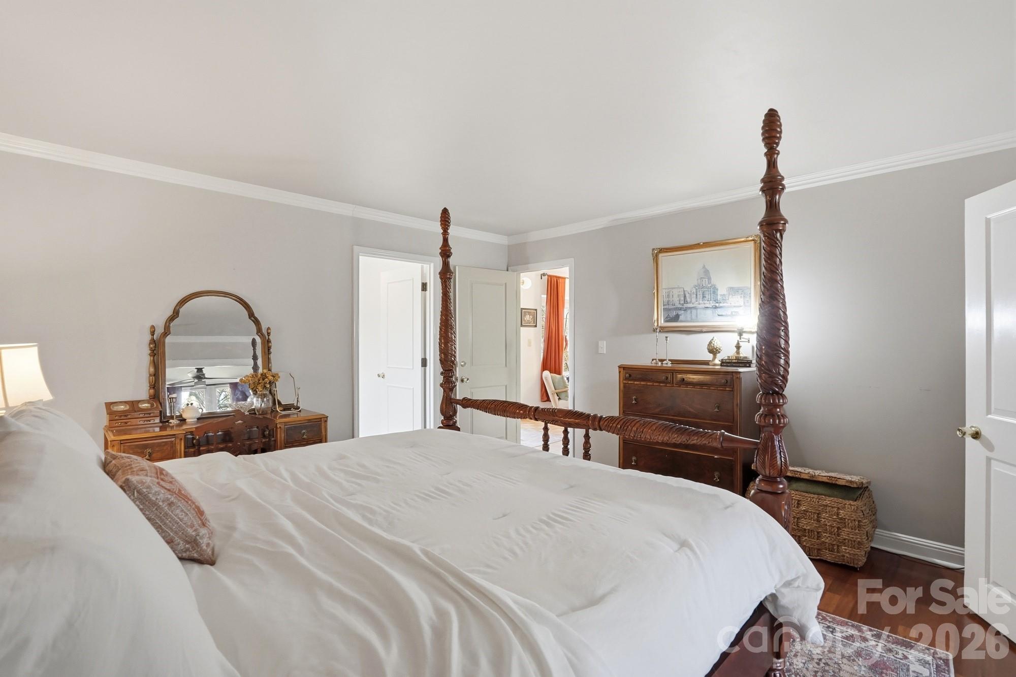 6046 Windjammer Drive Tega Cay, SC 29708 - Photo 24 of 46 a bedroom with a bed and a dresser with mirror