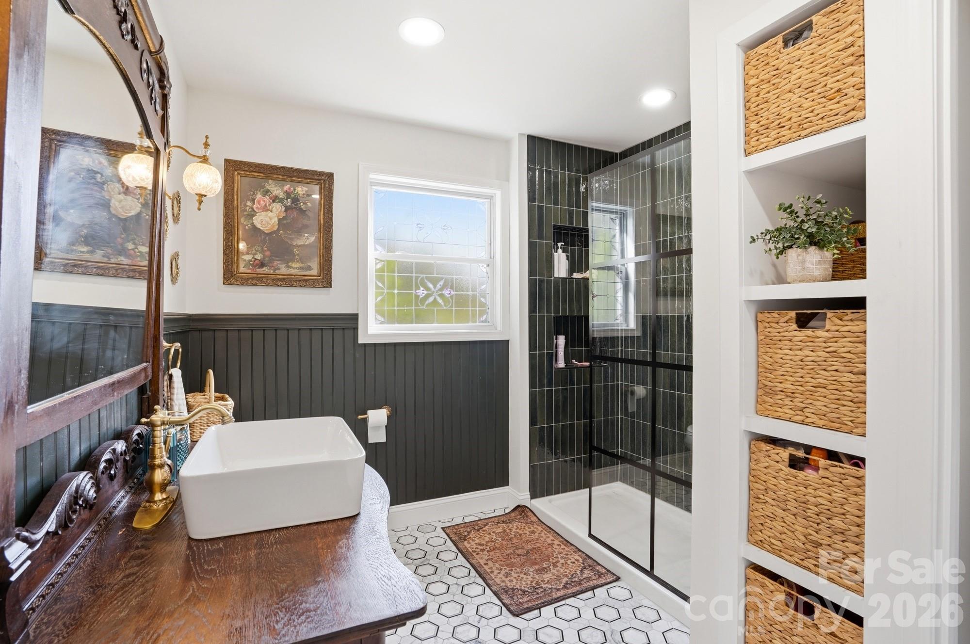 6046 Windjammer Drive Tega Cay, SC 29708 - Photo 25 of 46 a bathroom with a bathtub and a shower