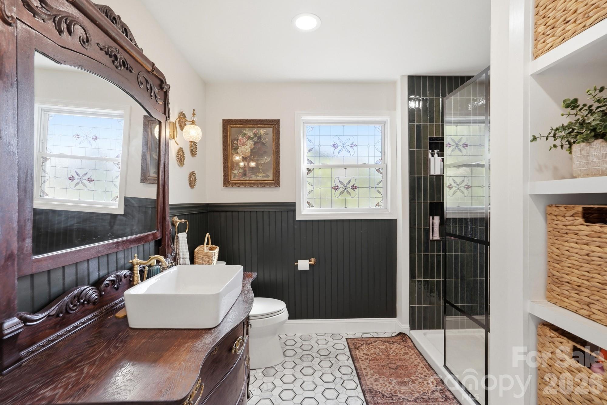 6046 Windjammer Drive Tega Cay, SC 29708 - Photo 26 of 46 a bathroom with a sink a toilet and shower
