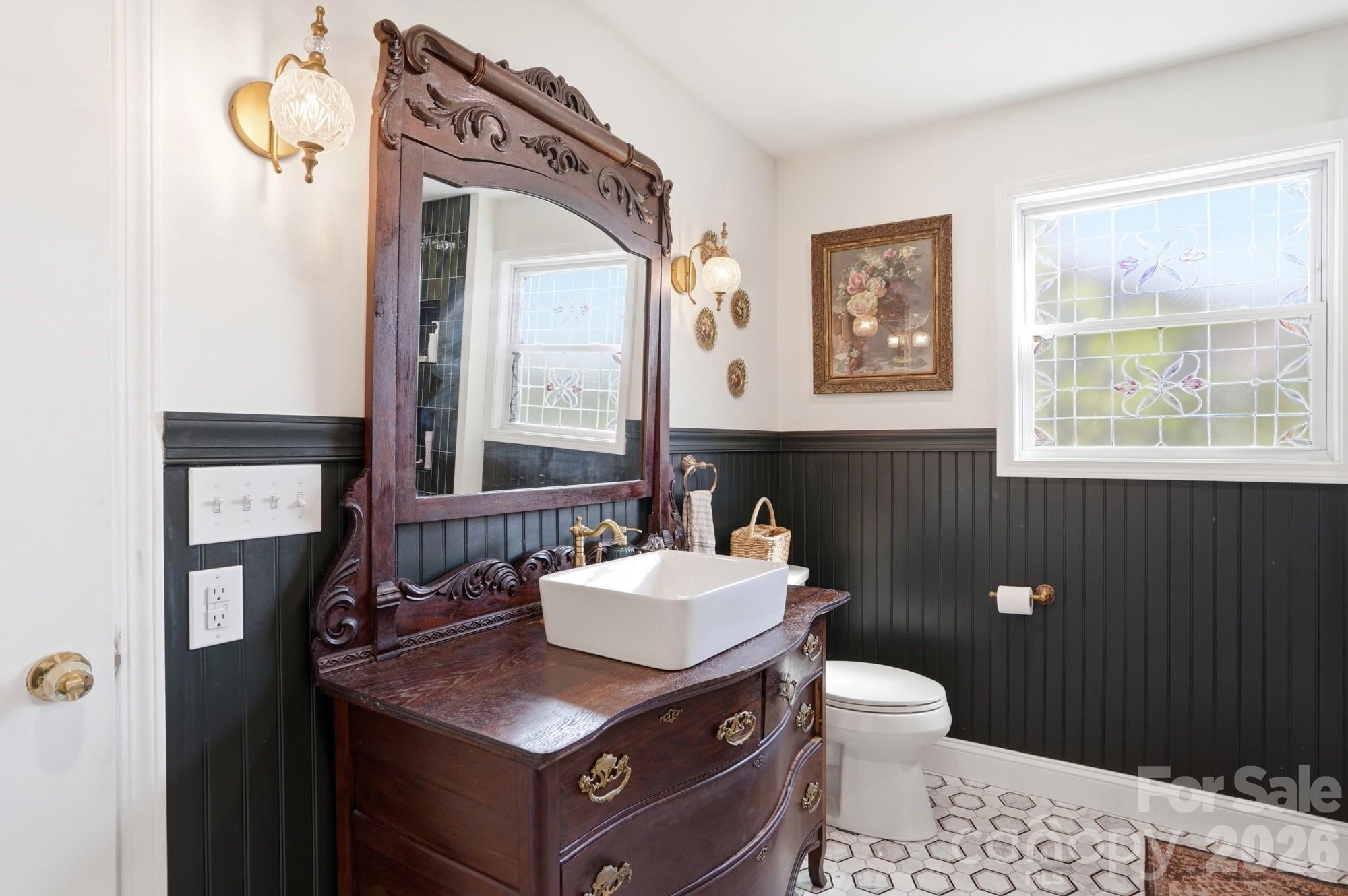 6046 Windjammer Drive Tega Cay, SC 29708 - Photo 27 of 46 a bathroom with a toilet a sink and mirror