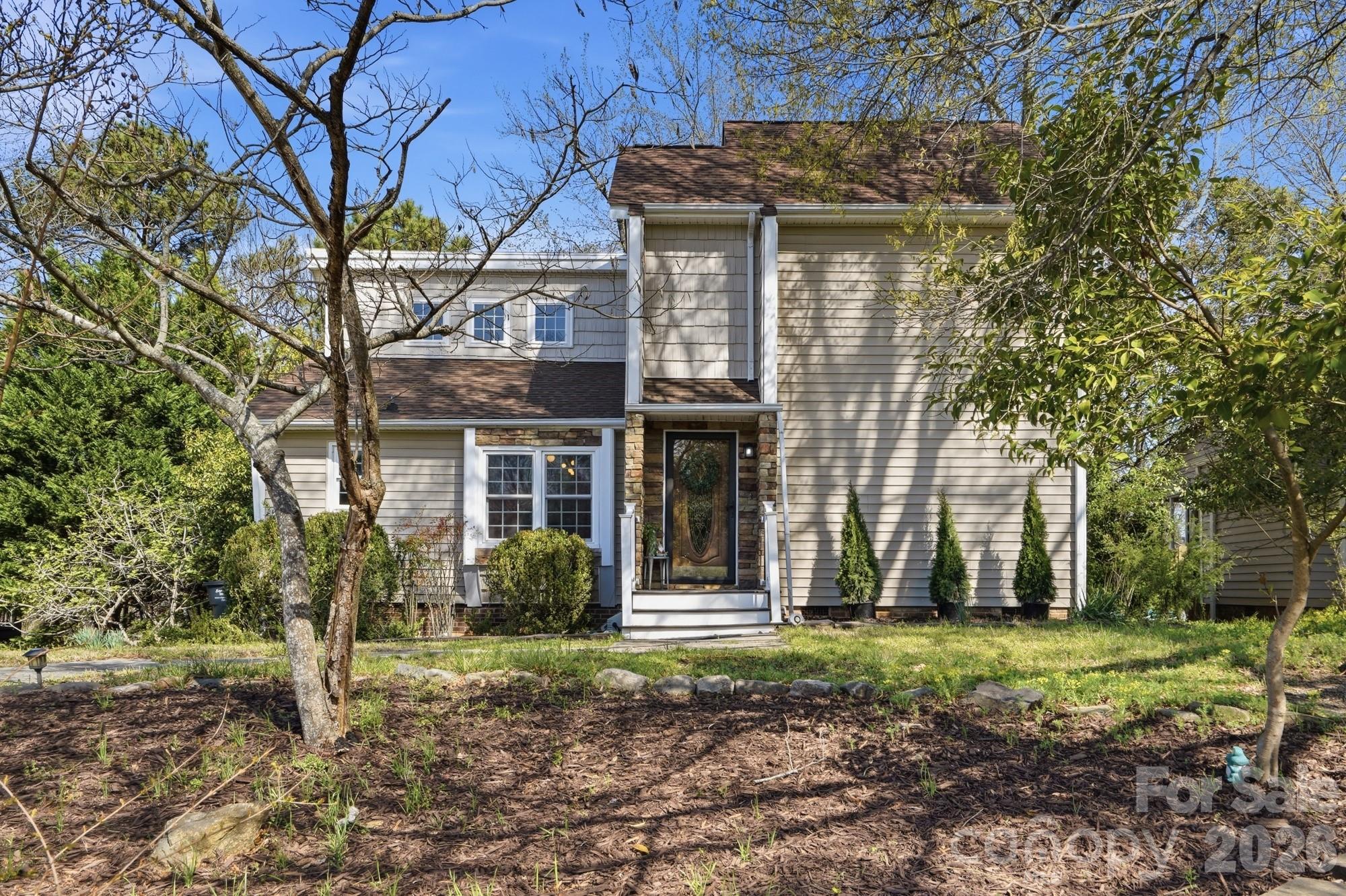6046 Windjammer Drive Tega Cay, SC 29708 - Photo 3 of 46 a front view of a house with garden