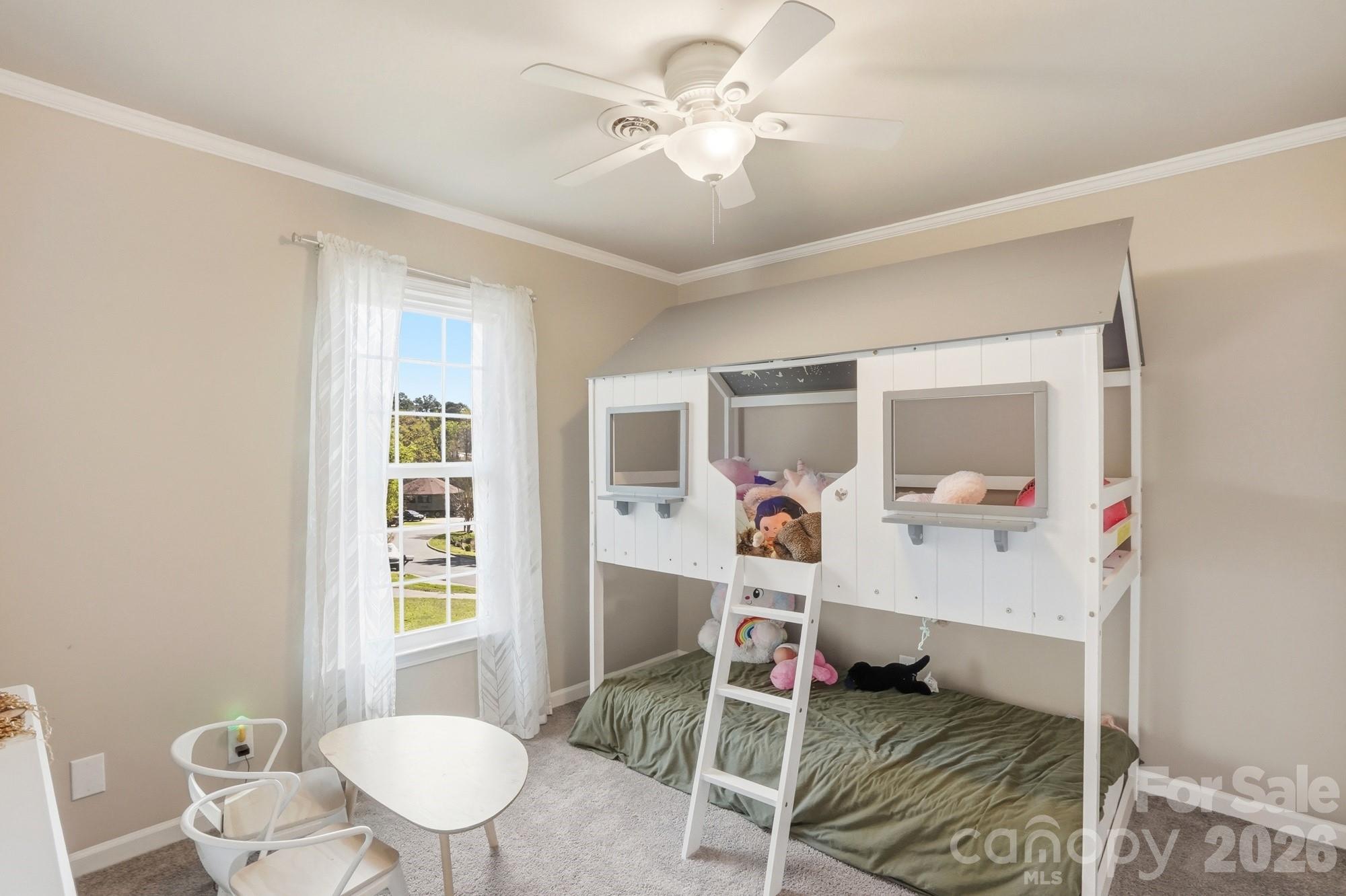 6046 Windjammer Drive Tega Cay, SC 29708 - Photo 36 of 46 a bedroom with a bed and a chandelier