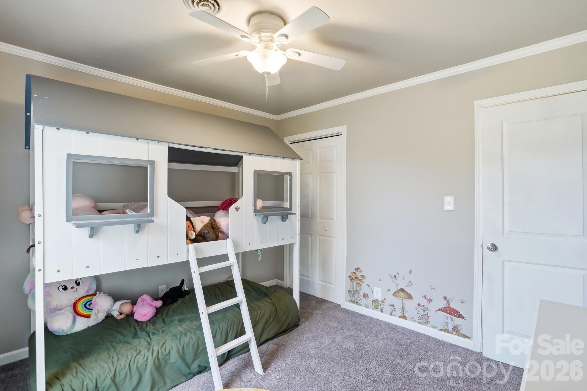 6046 Windjammer Drive Tega Cay, SC 29708 - Photo 37 of 46 a bedroom with a bed and a flat tv screen