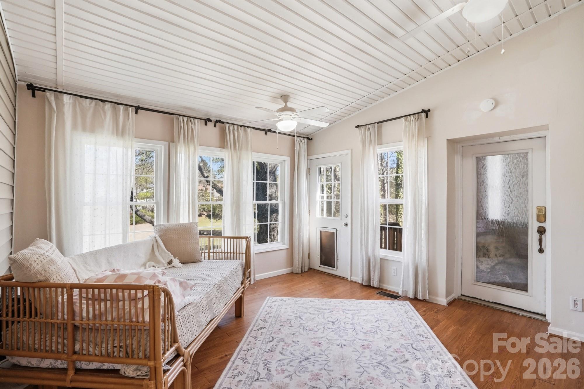 6046 Windjammer Drive Tega Cay, SC 29708 - Photo 39 of 46 a spacious bedroom with a bed and glass door