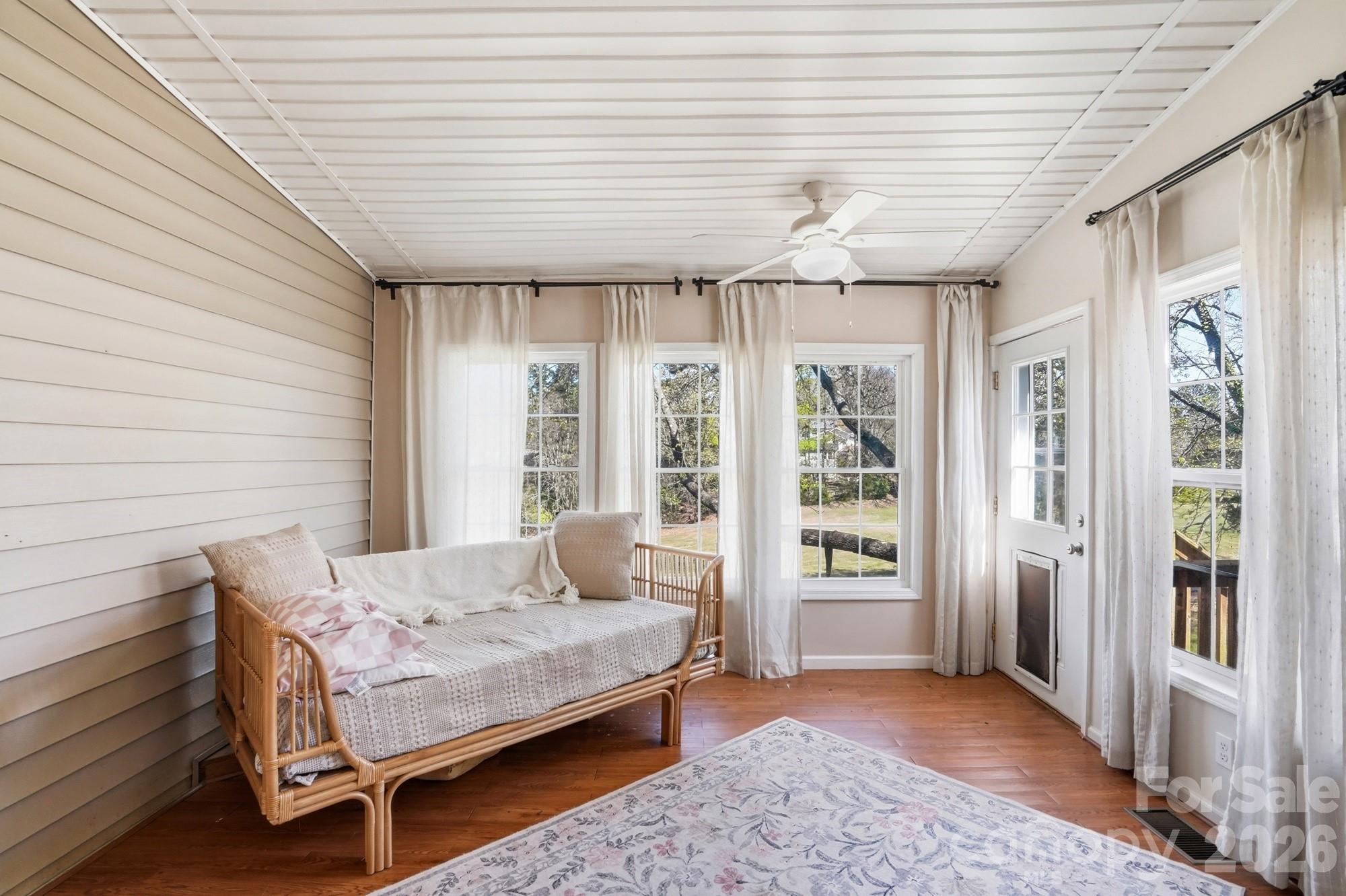 6046 Windjammer Drive Tega Cay, SC 29708 - Photo 40 of 46 a bedroom with a bed and a large window with balcony view