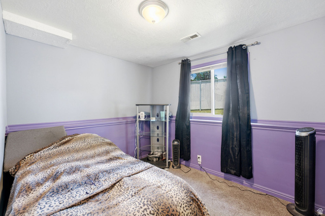 2475 Church Street Layton, UT 84040 - Photo 14 of 27 Windowed room featuring wall-to-wall carpeting and a two-tone wall treatment with a purple wainscoting