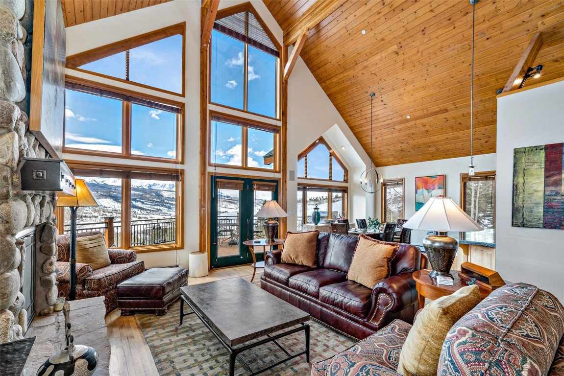 40 Nordic Trail Silverthorne, CO 80498 - Photo 2 of 35 a living room with furniture two large windows and a chandelier