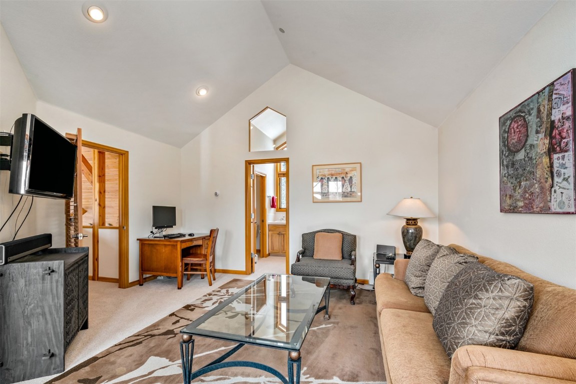 40 Nordic Trail Silverthorne, CO 80498 - Photo 22 of 35 a living room with furniture a flat screen tv and kitchen view